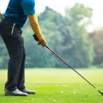 Golfers hit sweeping golf course in the summer