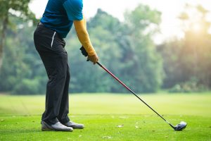Golfers hit sweeping golf course in the summer